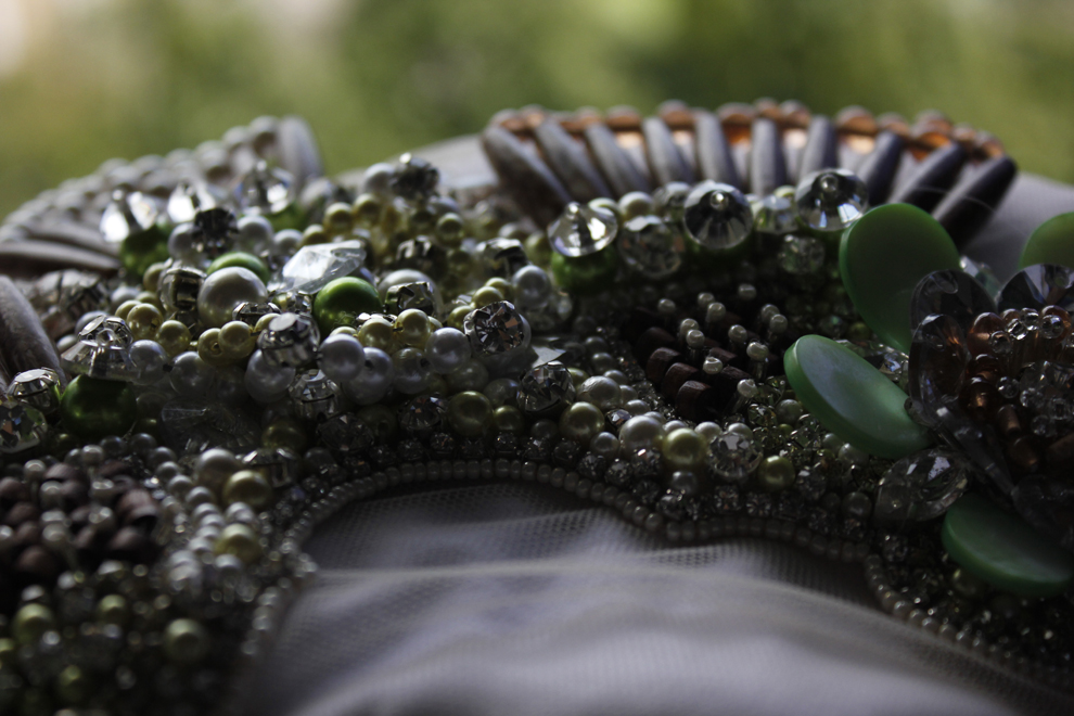 Green pearl and crystal mixed bead embroidery on grey fabric