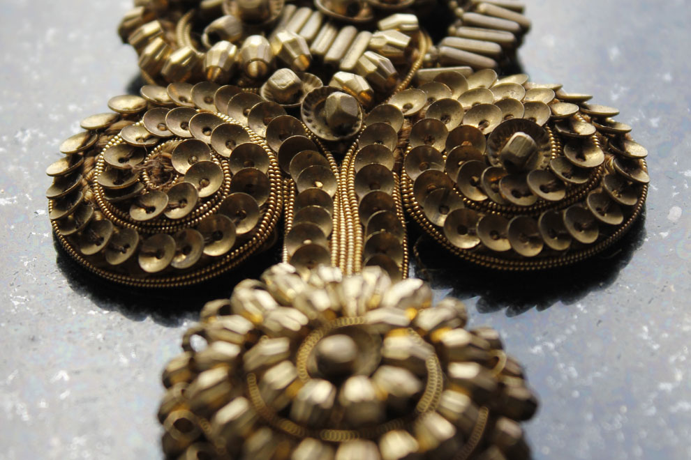 Black spiral beaded motif on white garment shoulder — Imroz Fashions